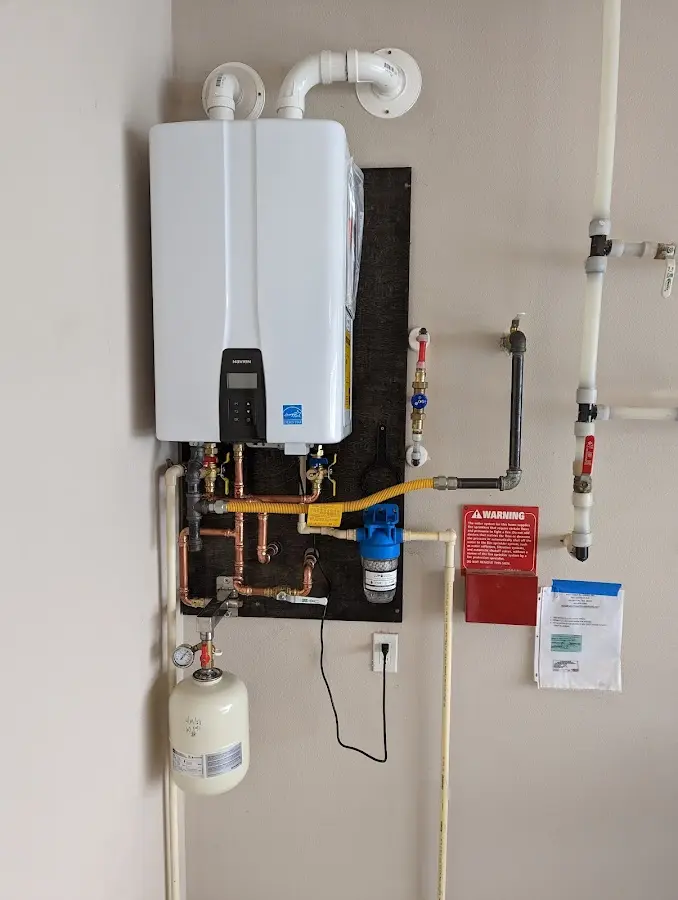 Professional plumber installing copper piping in a St. Anthony home